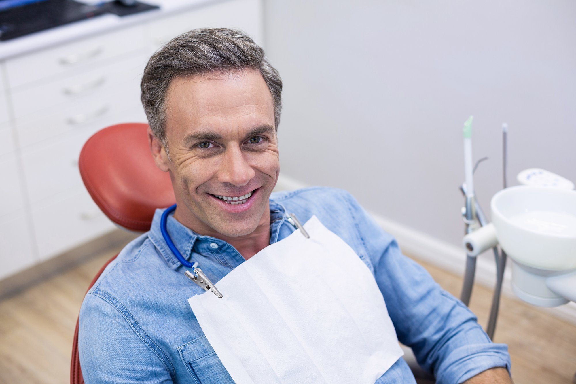 A dentist performing a gentle oral cancer screening